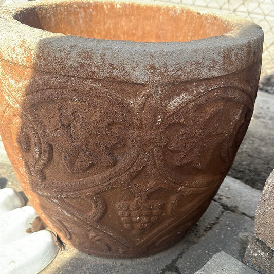 Terra-cotta colored grape plant pot